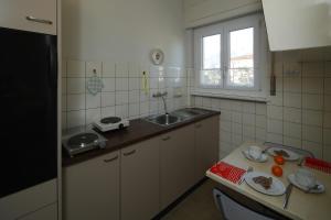 a small kitchen with a sink and a counter at Apartment Casa Thuja in Ascona +10 photos