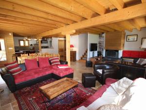 a living room with red furniture and a wooden ceiling at Chalet Hauteluce, 7 pièces, 12 personnes - FR-1-293-55 in Hauteluce