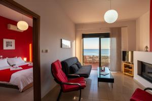 a bedroom with a bed and a living room at Caravella Luxury Apartments in Palaiochóra