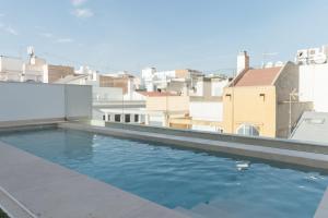 a swimming pool on the roof of a building at BN SUITES Teatro in Alicante