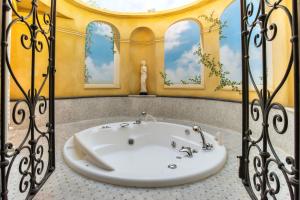 a bathroom with a bath tub in a room at Hotel Alba Palace in Florence