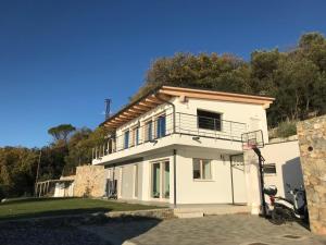 a white house with a basketball hoop in front of it at Belvedere20guesthouse in Finale Ligure