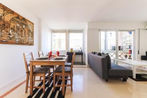 a kitchen and dining room with a table and chairs at Lisbon Flower 360º - Your Lovely Flat with Pool and Parking in Lisbon