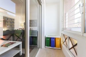 a small room with a window and a table at Lisbon Flower 360º - Your Lovely Flat with Pool and Parking in Lisbon +20 photos