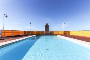 a swimming pool on the roof of a building at Lisbon Flower 360º - Your Lovely Flat with Pool and Parking in Lisbon