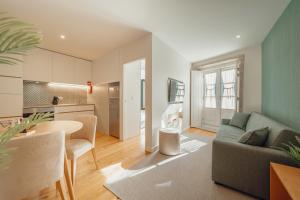 a living room with a couch and a table at River Eyes Apartments in Porto