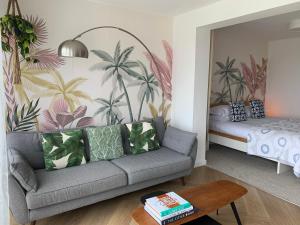 a living room with a couch and a bed at Porth Beach Hotel in Newquay +37 photos