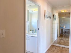 a bathroom with a white sink and a mirror at 9 Summerplace in Knysna +31 photos