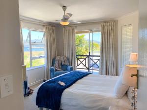 a bedroom with a bed and a view of the ocean at 9 Summerplace in Knysna