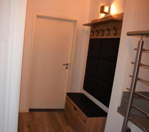 a closet with a white door and a black shelf at Ferienhaus Hanni in Geeste