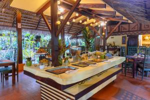 a buffet in a restaurant with food on a table at Shawandha Lodge in Puerto Viejo