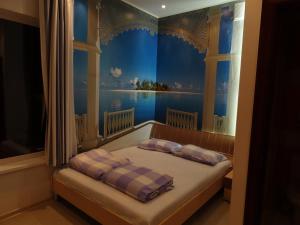 a bedroom with a bed with a painting on the wall at Vacation House in Truskavets