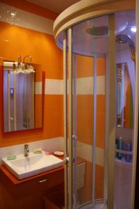 a bathroom with a shower and a sink at Vacation House in Truskavets