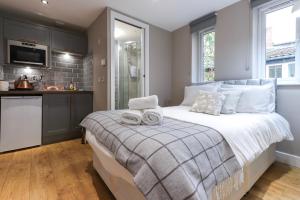 a bedroom with a large bed with towels on it at Old Market Apartments in Bristol