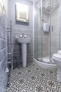 a bathroom with a sink and a shower at Old Market Apartments in Bristol