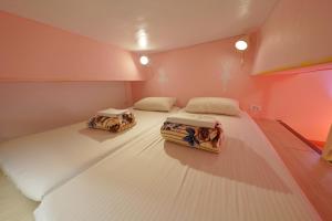 A bed or beds in a room at 安蘭居旅店 An Lan Jie Hotel