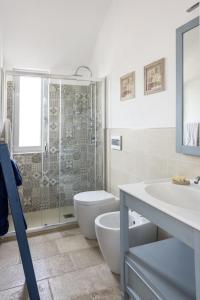a bathroom with a shower and a toilet and a sink at le dimore di Ma Ma in Ceglie Messapica +44 photos