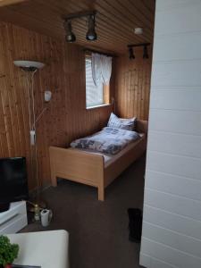 a bedroom with a bed and a window at Pension Parkblick in Braunlage