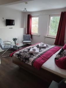 a bedroom with a bed with two towels on it at Pension Parkblick in Braunlage