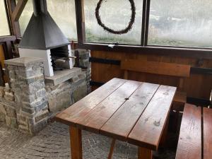 a wooden bench sitting in front of a window at Chata Rožany in Šluknov