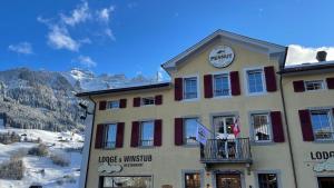 un edificio con un cartel en el costado en Peanut Mountain Lodge & Le Communal en Val dʼIlliez