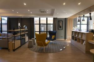a living room with two chairs and a table at Floridianes by HRI in Aix-en-Provence +57 photos