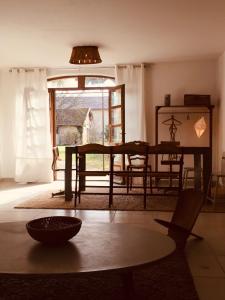 a living room with a table and a window at Ferme St Pierre gîte autonome 2-4 personnes in Chabeuil