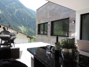 a house with a view of the mountains at Aparthotel Adrenalin in Kappl