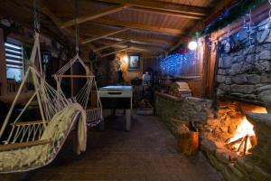 a room with a fireplace and a stone wall at Bacówka u Winiarskich in Nowy Targ