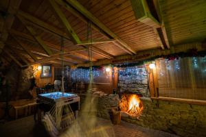 a room with a fireplace and a stone wall at Bacówka u Winiarskich in Nowy Targ