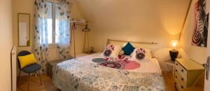 a bedroom with a bed and a chair at Ty Ana in Ploubazlanec