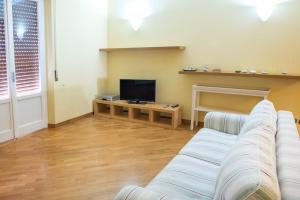 a living room with a couch and a tv at S34 - Sirolo, quadrilocale in centro arredato con gusto in Sirolo