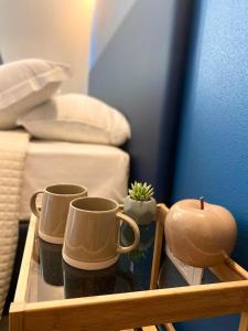 bandeja de madera con 3 tazas de café y cactus en La casina rossa Affittacamere en La Spezia