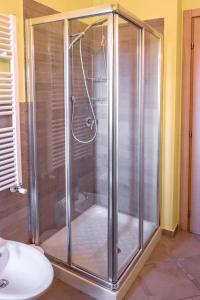 a shower with a glass door in a bathroom at S34 - Sirolo, quadrilocale in centro arredato con gusto in Sirolo