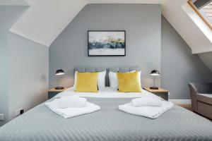 a bedroom with a large bed with yellow pillows at The Gem Of Central Winchester - Sleeps 4 in Winchester