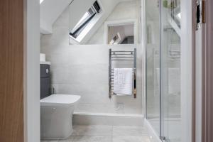 a bathroom with a toilet and a glass shower at The Gem Of Central Winchester - Sleeps 4 in Winchester
