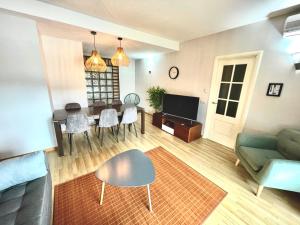 a living room with a couch and a table at SeaHomes Vacations, FENALS BEACH&CHIC, pk, top apartment full equipped in Lloret de Mar