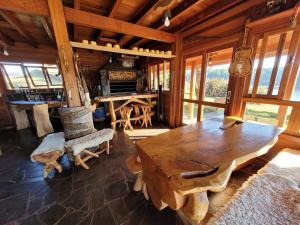 a large wooden table and chairs in a room at Hotel Fazenda Boutique Terra do Gelo in Bom Jardim da Serra