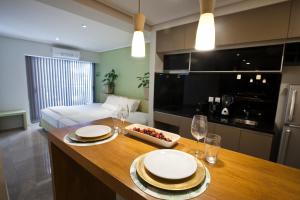 a kitchen with a table with plates and wine glasses at Le Montreal Apartments in Mendoza
