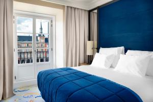 a hotel room with a bed and a window at Pestana Plaza Mayor Madrid in Madrid