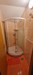 a shower with a glass door in a bathroom at Casa Cristal in Eforie Sud