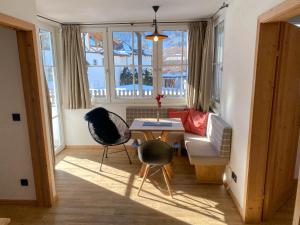 a living room with a table and two chairs at Suiten Am Schloss in Kitzbühel