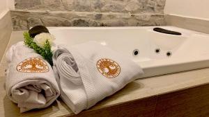 a white bath tub with towels and flowers on a counter at Atrani in Santeagueda +26 photos