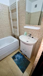 a bathroom with a sink and a toilet and a tub at Cozy Studio in Brăila