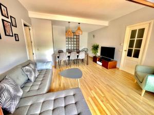 a living room with a couch and a table at SeaHomes Vacations, FENALS BEACH&CHIC, pk, top apartment full equipped in Lloret de Mar