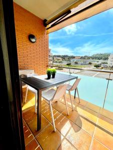 a black table and chairs on a balcony with a view at SeaHomes Vacations, FENALS BEACH&CHIC, pk, top apartment full equipped in Lloret de Mar