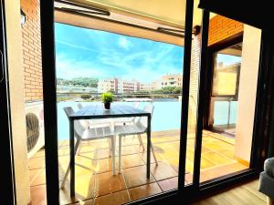 a table on a balcony with a view of a pool at SeaHomes Vacations, FENALS BEACH&CHIC, pk, top apartment full equipped in Lloret de Mar