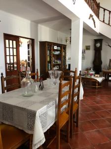 a dining room with a table with a white table cloth at vivenda descollaz in Falcoeiras