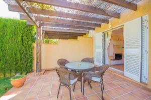 a patio with a table and chairs on a patio at Bungalow Azalea - PlusHolidays in Calpe