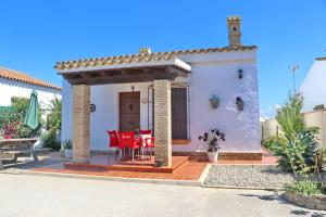 a house with a table and chairs on a patio at Chalet Chaparrillo in Conil de la Frontera
